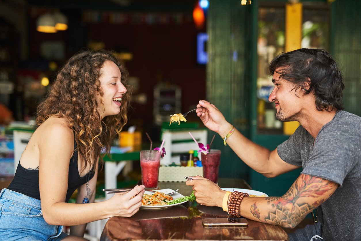 Shot of two young tourists enjoying lunch together in a restaurant